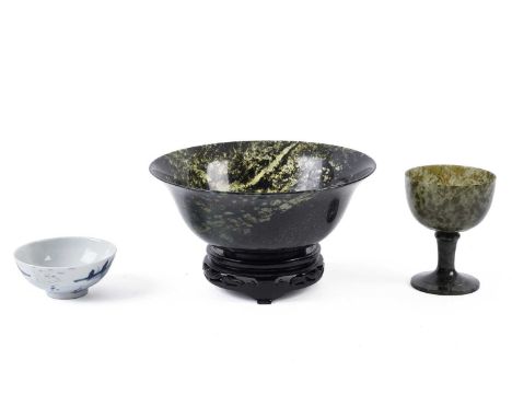 A spinach green carved hardstone bowl, raised on a carved hardwood stand, 19.5cms diameter; together with a similar green har