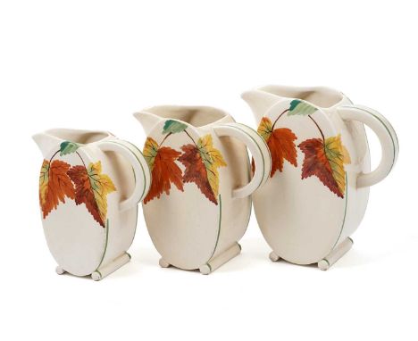 A Royal Staffordshire A.J Wilkinson ‘Honeyglaze’ pattern set of three graduated jugs, circa 1940s, decorated with autumnal le