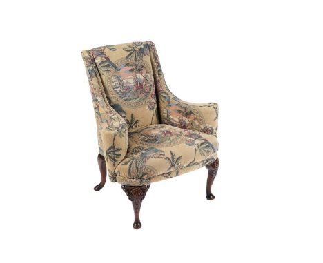 A Georgian style mahogany framed wingback armchair, upholstered in decorative tapestry upholstery depicting a North African s