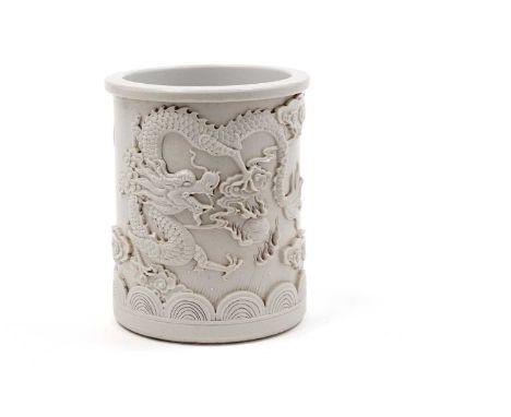 A Chinese 'Blanc de Chine' bitong, sprigged in high relief with a dragon and flaming pearl amongst clouds, impressed seal mar