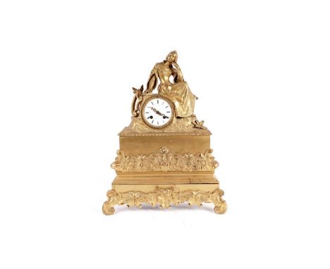 Mazilier a Metz: a 19th Century ormolu mantel clock, white enamel Roman dial, the case with recumbent lady next to a harp, tw