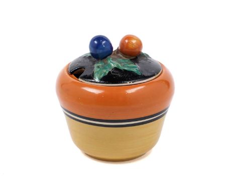 A Clarice Cliff Bizarre preserve pot and cover, with fruiting bough finial on black ground, banded with orange, yellow, and b