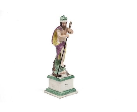 An early 19th Century Staffordshire pearlware figure of Neptune, on dolphin support, metal trident, the square base impressed