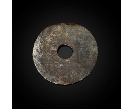 MOTTLED DARK BROWNISH-GREEN JADE DISC, BI  NEOLITHIC PERIOD, LIANGZHU CULTURE 新石器時代 良渚文化 玉璧刻款: 細起花文若有神/撫無留手卻平勻/知其是玉疑非玉/謂此非珍孰是