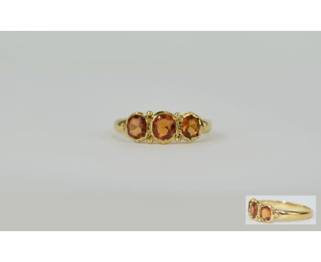 18ct Gold Brazilian Imperial Topaz Set Ring. Marked 18ct. The three Imperial topaz of the highest quality. 4.1 grammes. Ring 