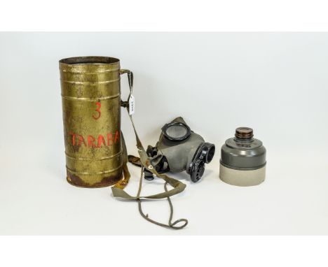 Gas Mask Authentic gas mask in field green rubber housed in original tin with webbing carry handle. Marked K 132 61-52 to bas