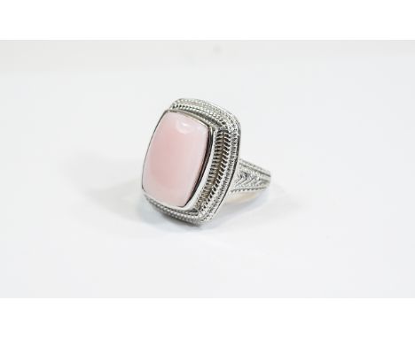 Pink Opal Cabochon Ring, an elongated cushion cut cabochon of pink opal, measuring 11.75cts, bezel set in platinum vermeil an