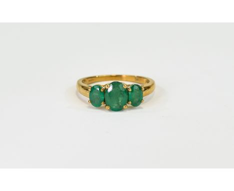 Emerald Three Stone Ring, an oval cut emerald of 1.25cts, flanked by two further oval cut emeralds, each of just under .5ct, 