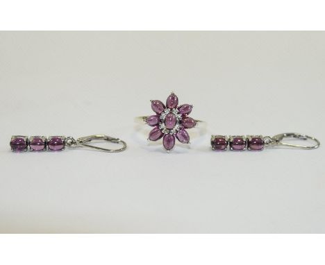 Rhodolite Garnet Cluster Ring and Drop Earrings, the ring comprising nine oval cut, plum colour garnet cabochons set in an ov
