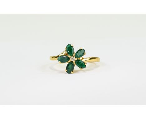 Emerald and White Topaz Flower Ring, five oval cut emeralds, mined in Brazil, centred by a round cut white topaz, totalling 1