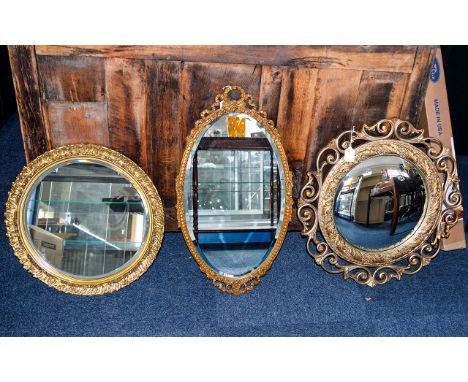 Gilt Framed Mirrors Three in total, the first a circular bevelled glass mirror in ornate yellow gilt distressed frame. The se