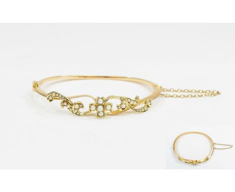 Antique Period 15ct Gold Hinged Bangle set with seed pearl and attached gold safety chain. Marked 15ct. Nice quality period p