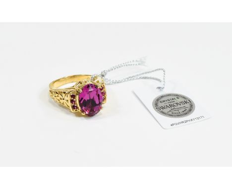 Swarovski Fuchsia Crystal Ring, an oval cut fuchsia pink crystal set between two rows of three tiny, similar crystals, in a g