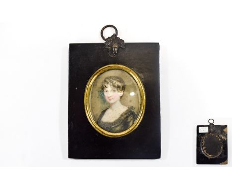 Victorian Hand Painted MIniature Portrait of a young woman with brown hair wearing a dark coloured low cut dress with a black