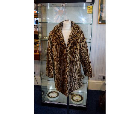 Ocelot Fur Coat Mid length vintage coat with revere collar and side seam pockets. Hook and eye fastening, lined in brown geom