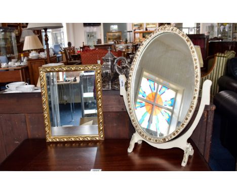 Mirrors Two in total, the first a small swivel dressing table mirror of oval form in fancy cream frame/stand. The second a sm