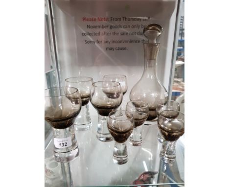 A CAITHNESS SMOKEY GREY DECANTER AND TWO SETS OF 4 GLASSES
