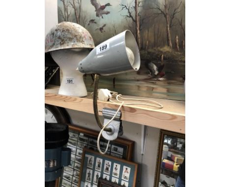 A vintage industrial adjustable spot light with flexible brass neck