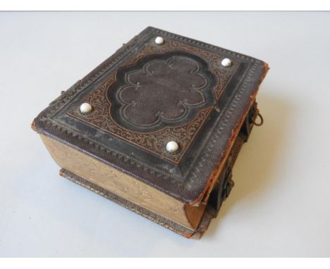 AN AMERICAN 19TH CENTURY LEATHER BOUND PHOTOGRAPH ALBUM, comprised of portrait photographs from the era, 6.5 x 12.5 x 15.5 cm