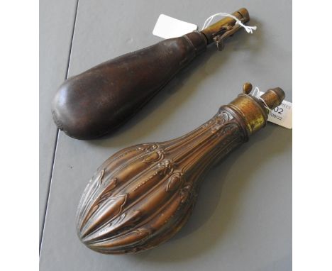 A 19TH CENTURY COPPER AND BRASS POWDER FLASK&nbsp;with fluted foliate decoration and a leather shot flask, 21 cm long.