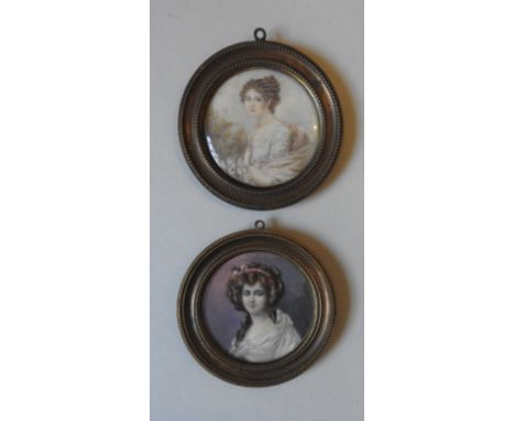 A PAIR OF EARLY 19TH CENTURY PORTRAIT WATER COLOURS OF REGENCY LADIES, in circular frames, 5.5 cm diameter