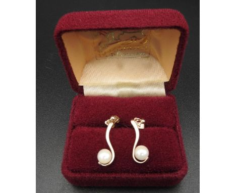 A PAIR OF CULTURED PEARL EARRINGS  Of crossover design mounted in 9ct gold Marked B&amp;S, 9ct, Birmingham, 1990. Weight 2.4g
