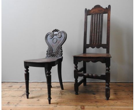A 19TH CENTURY MAHOGANY HALL CHAIR, with lyre shaped scroll carved back panel, along with an oak 19th century high back chair