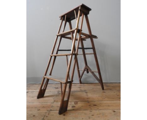 A VINTAGE PINE FOLDING STEP LADDER, the four tread ladder with a fold down table top, 114 x 45 cm 