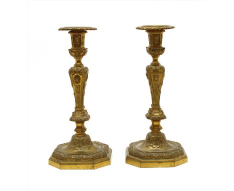 A pair of French ormolu candlesticks, 19 th century, with portrait medallions to the columns, drilled for electric fittings ,