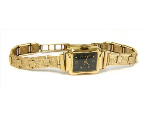A ladies' gold Anker mechanical bracelet watch, black enamel dial with raised gilt metal hour markers and Arabic numerals at 