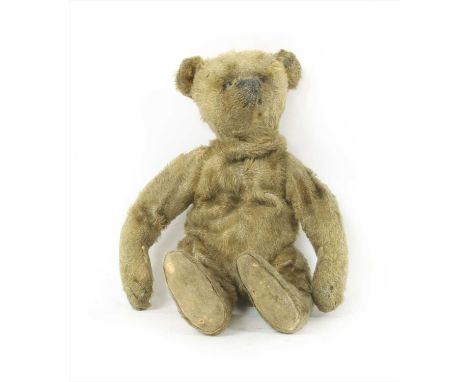 An early 20th century Steiff brown plush teddy bear, with moveable limbs and growler (a.f), button to ear, 20cm long, circa 1