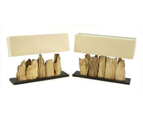 A pair of driftwood lamp bases, made of shards of driftwood, on a black rectangular base with calico shades, 80cm wide, 20cm 