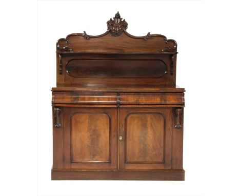 A 19th century mahogany chiffonier , the superstructure with a carved scrolling top rail and a stylised leaf motif to the cen