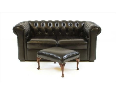 A black leather two seater Chesterfield sofa, together with a black leather foot stool (2)