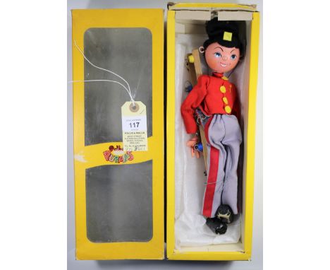 Pelham Puppet Soldier 'Fritzi'. In a scarlet jacket, with yellow buttons, grey trews with red stripe and black Busby style-sh