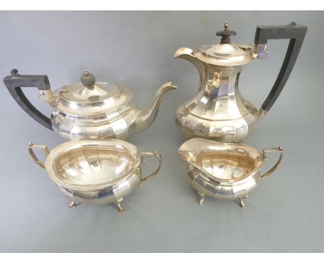 A heavy four-piece hallmarked silver tea service comprising teapot, hot-water jug, two-handled sugar and creamer, maker's mar