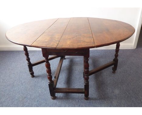 A late 17th/early 18th century oval oak dropleaf dining table; single end drawer and bobbin-turned supports (136cm leaves up 