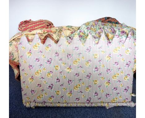 An upholstered bedhead in purple, yellow and green decorated with roses (90cm x 138cm), together with two matching curtains w