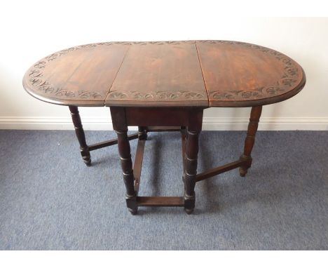 An antique oval oak drop-leaf gateleg table; the border decorated with incised lunettes,&nbsp;bulbous bobbin-turned style sup