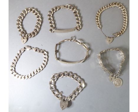 Seven heavy silver bracelets to include two identity bracelets and a silver gate-style bracelet (total weight approx. 277g) (