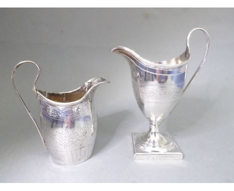 A George III period hallmarked silver helmet-shaped cream jug with high arch handle and a band of bright-cut engraving, centr