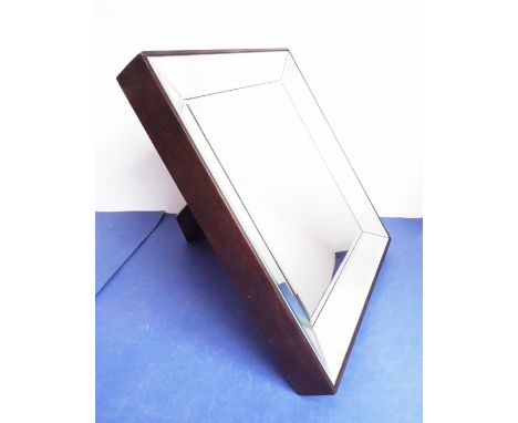 A heavy mahogany-framed easel-style&nbsp;mirror with angular bevelled&nbsp;mirror borders; the back with&nbsp;wall mountings 