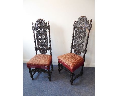 A fine pair of late 19th century carved oak chairs in late 17th century Charles II-style; each with high arched top rail carv