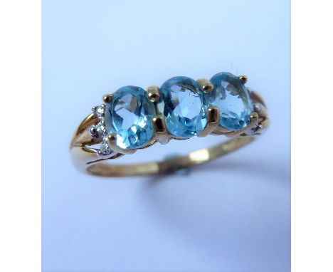 A 9-carat gold gem-set ring with aquamarine and diamond chips (boxed)  (The cost of UK postage via Royal Mail Special Deliver
