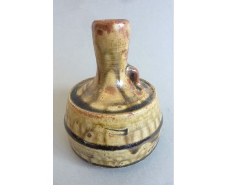 An unusual Winchcombe Pottery vase by John Jelfs; tall slightly flaring neck and a larger circular body with green and brown 