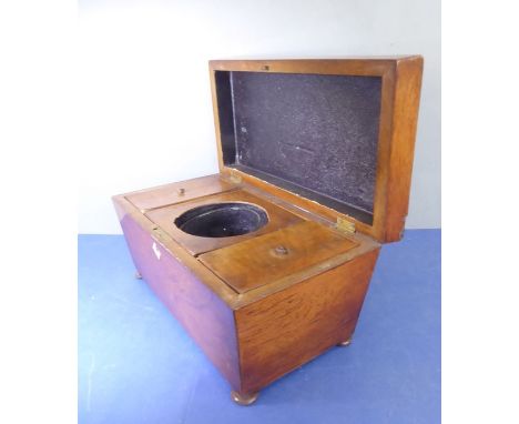 An early 19th century sarcophagus-shaped tea caddy; three interior compartments, the central compartment with later mixing gl
