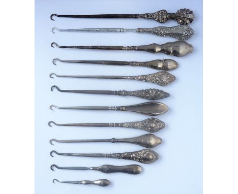 Twelve silver-handled button hooks