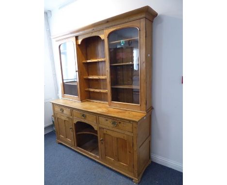 A good large late 19th century pine dresser; the shaped cornice above a centrally shelved superstructure flanked by two arch 