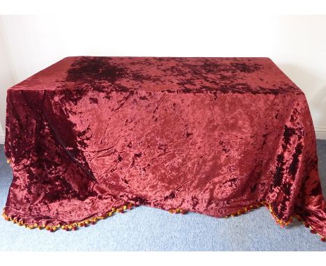 A burgundy crushed velvet/een bed cover lined with heavy gold crepe and with pom-pom edging (320cm x 296cm) (some loose stitc
