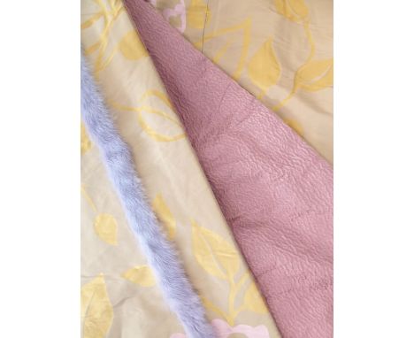A pair of silk curtains in a modern floral design of pink and gold edged with lilac fur-effect fabric from Nobili and Pierre 